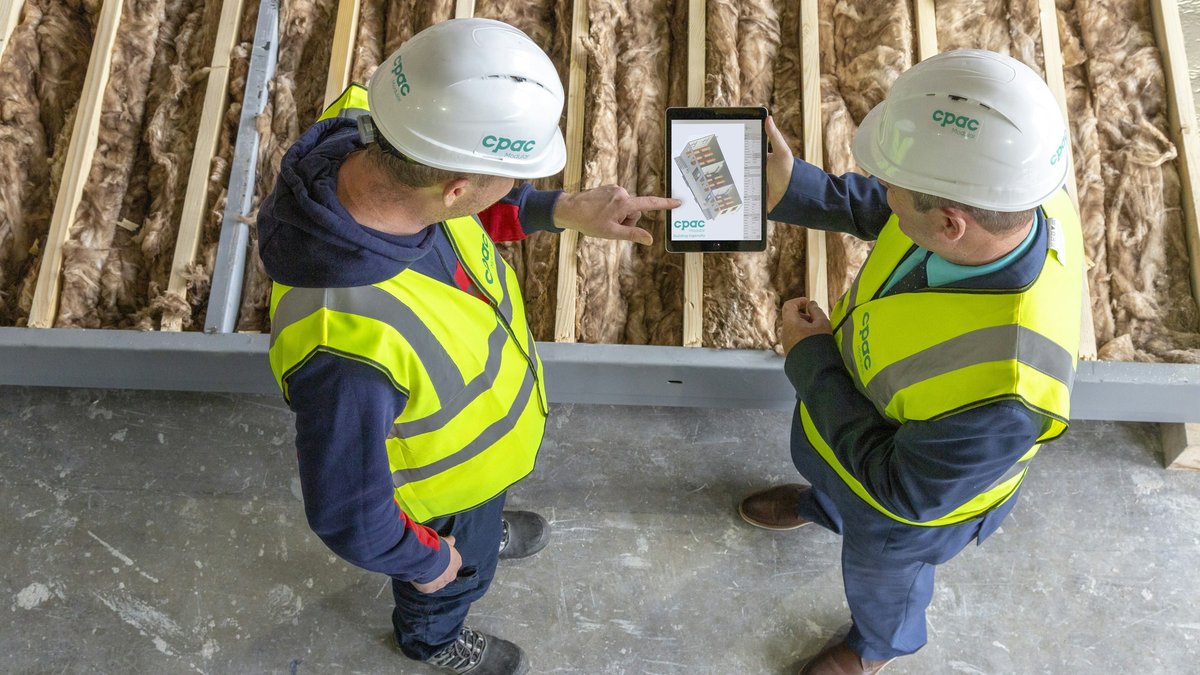 Reviewing the plans inside the framing of a new home