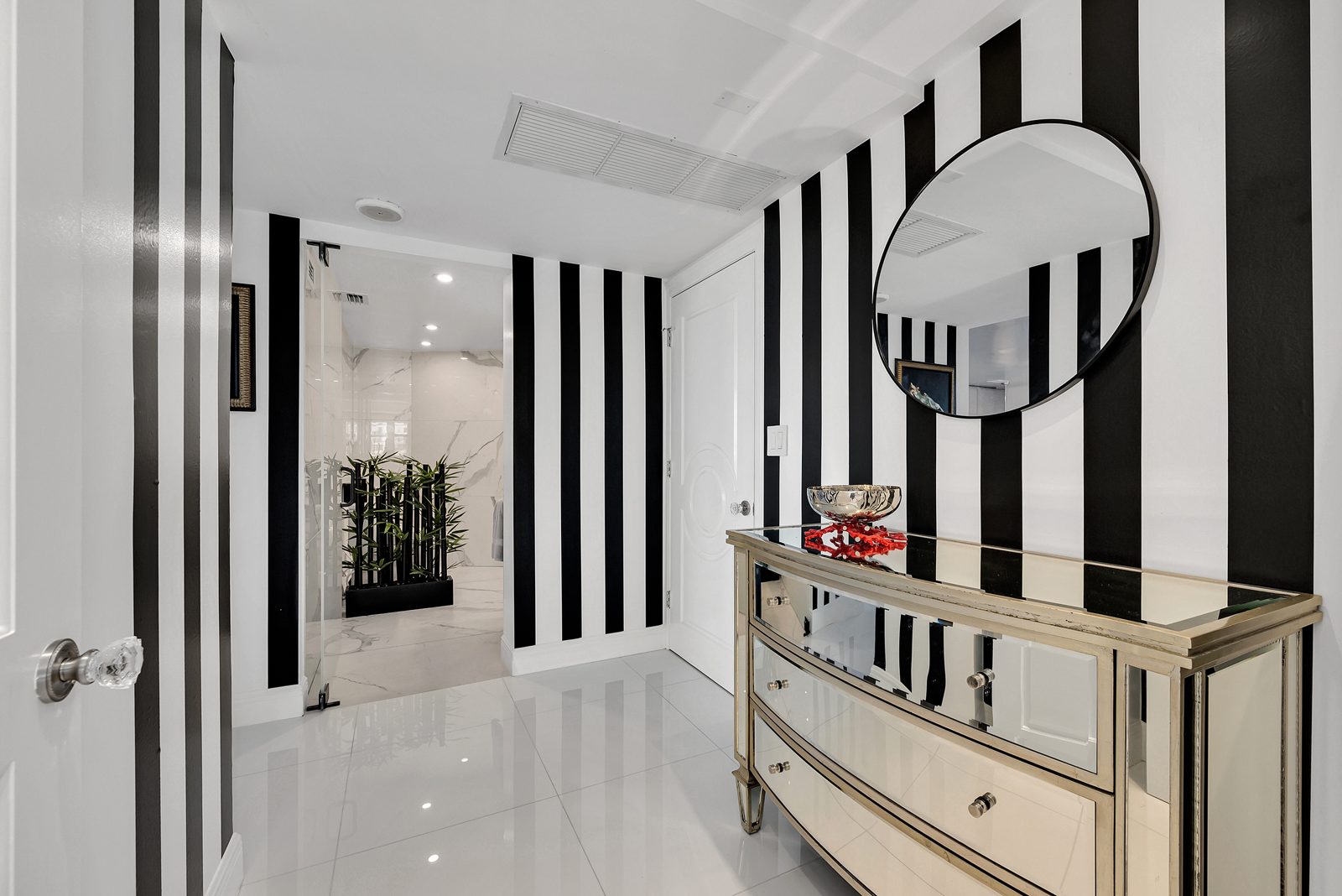 Diane's black-and-white striped hallway with a round mirror