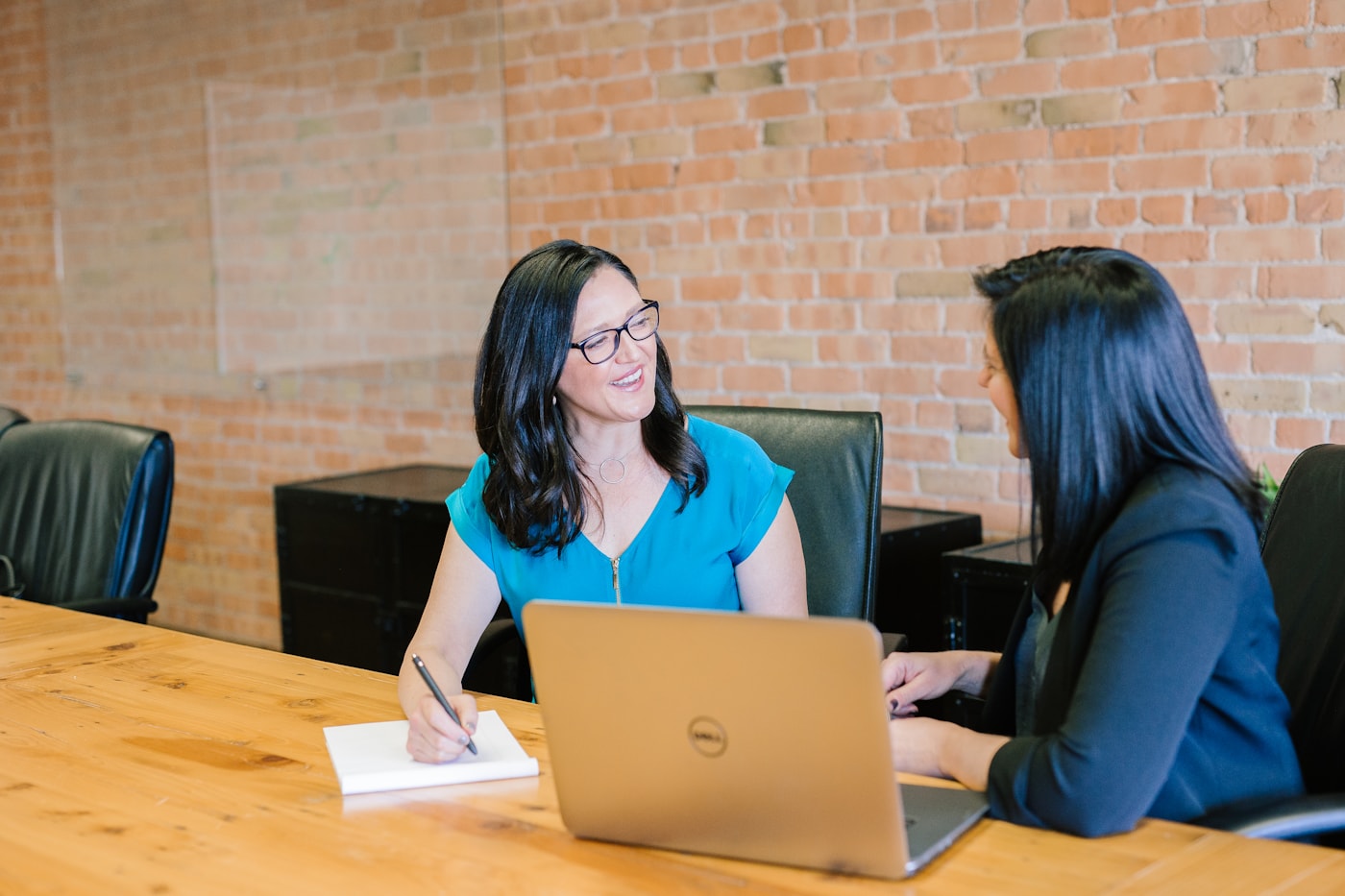 Two women reviewing closing figures and documents together at a table