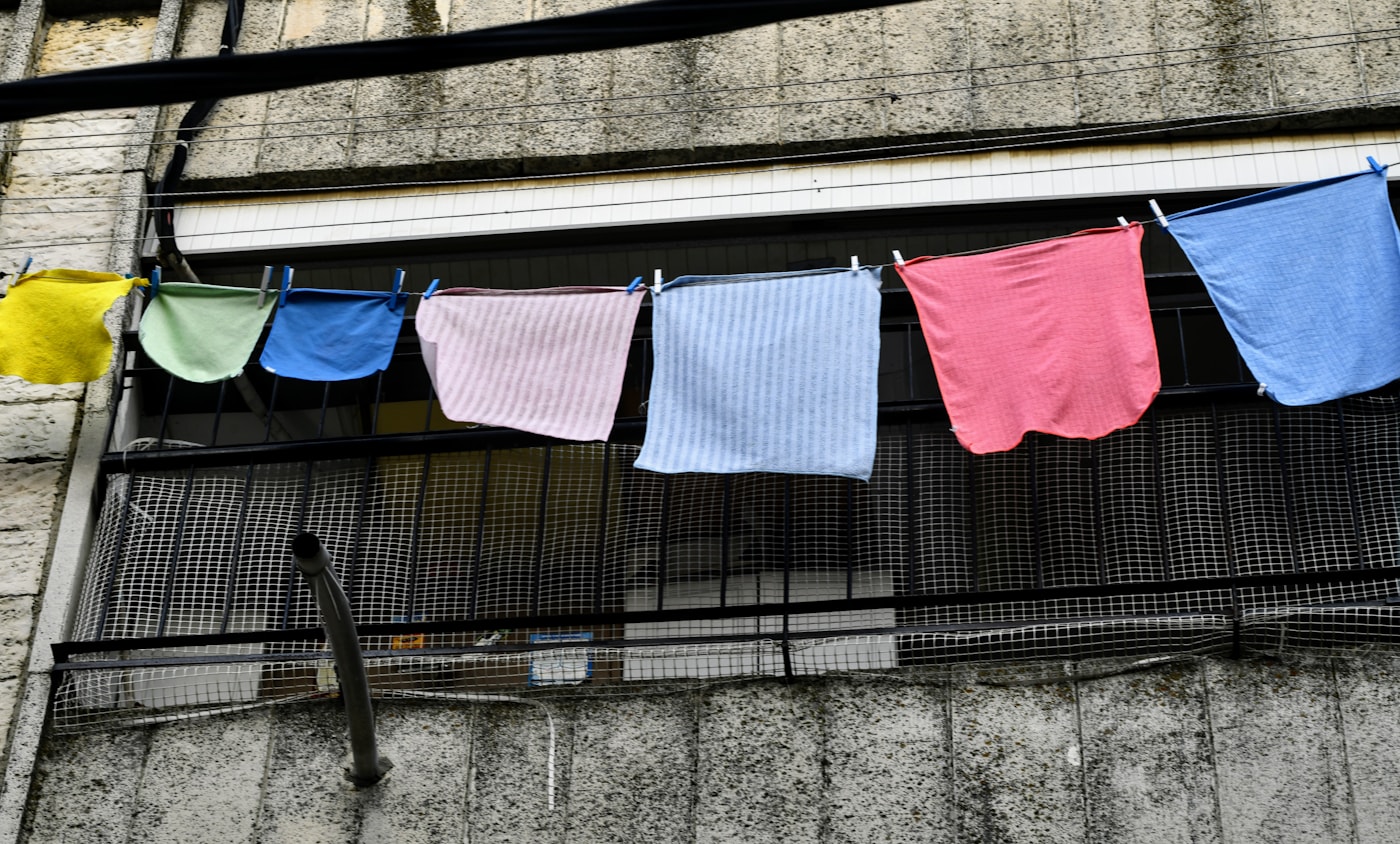 Colorful freshly washed towels drying on a clothesline