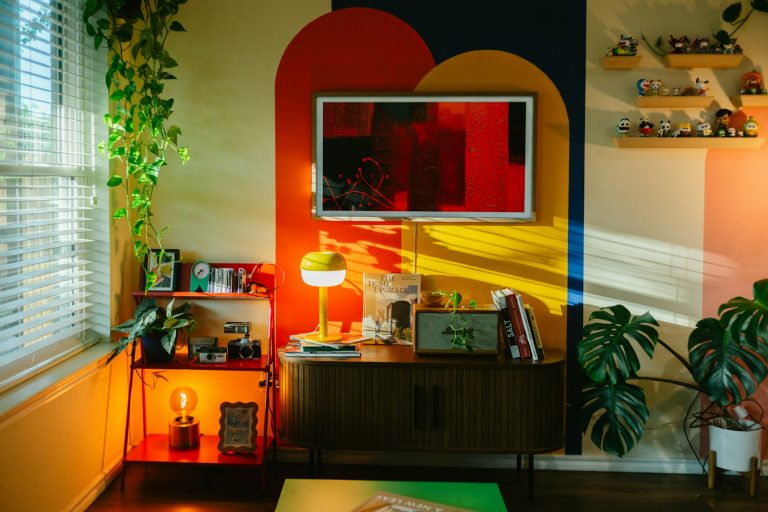 Colorful eclectic living room with geometric wall art and green plants