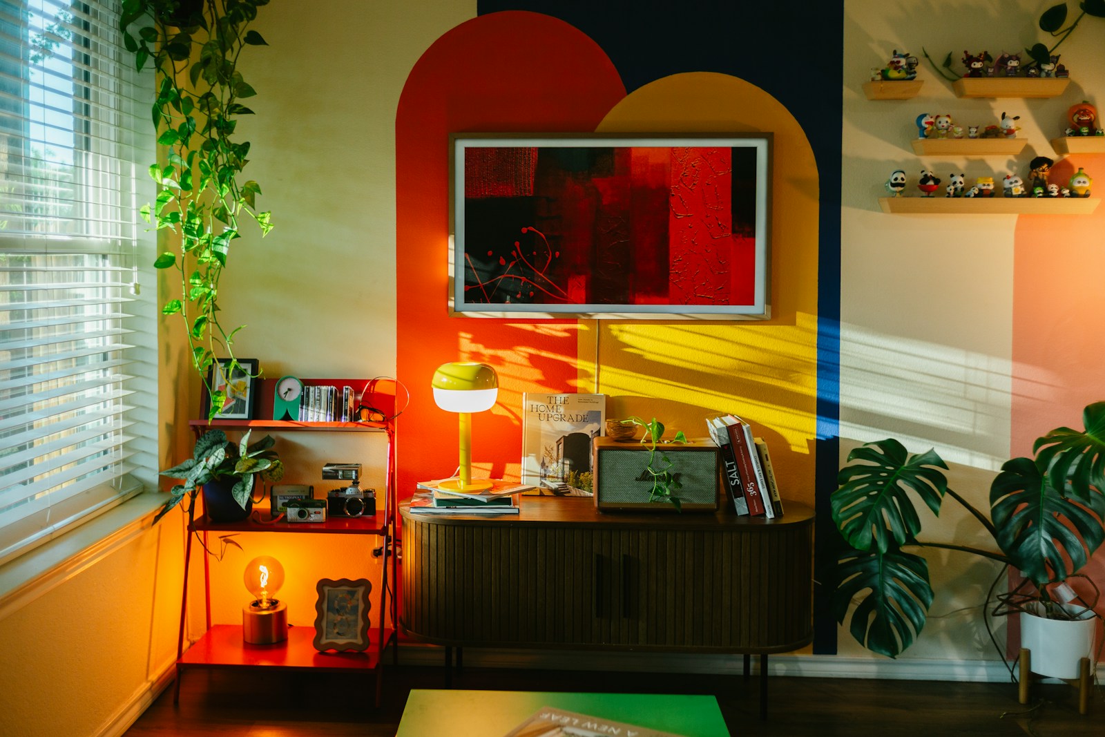 Colorful eclectic living room with geometric wall art and green plants