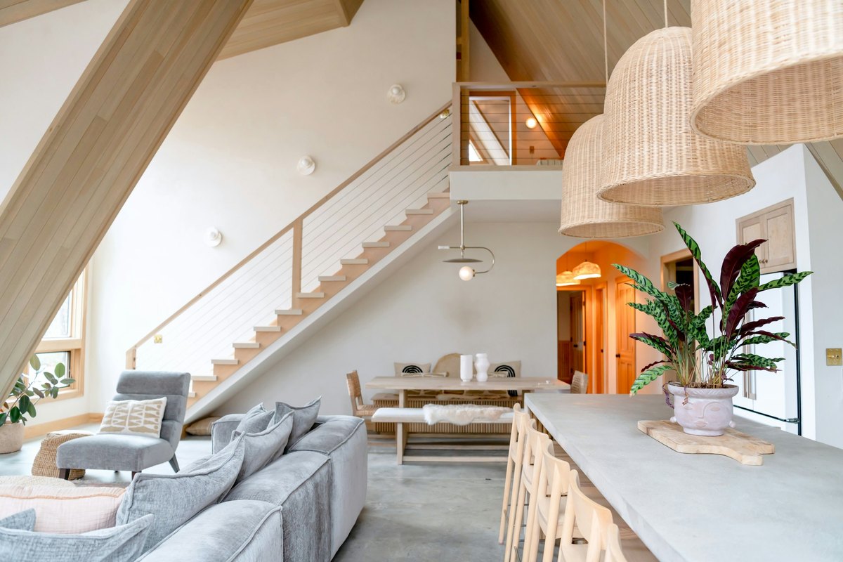 A bright living room with woven pendant lights over the seating area