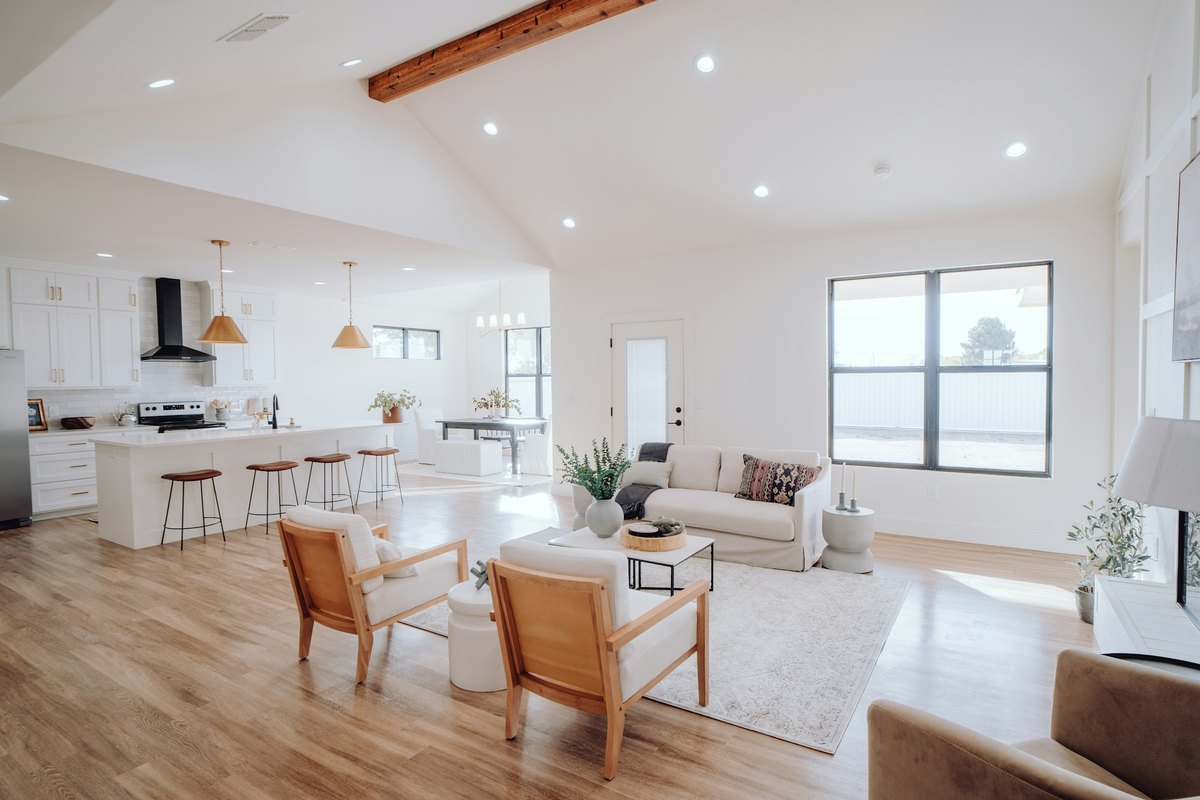 A bright open-plan living room flowing into the kitchen