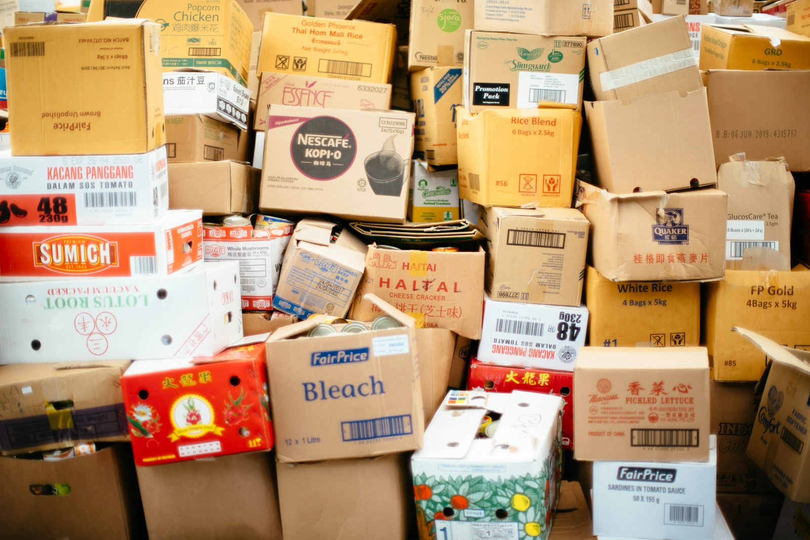 A wall of colorful printed cardboard boxes stacked floor to ceiling